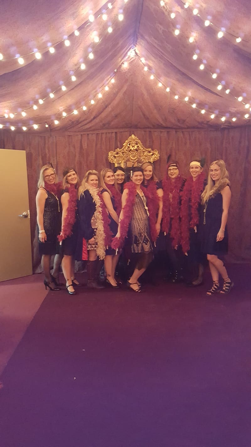 Team at an evening event under string lights