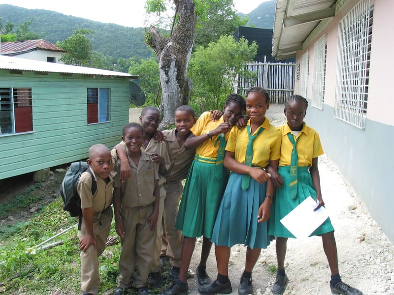 Schoolchildren in uniforms outside their school