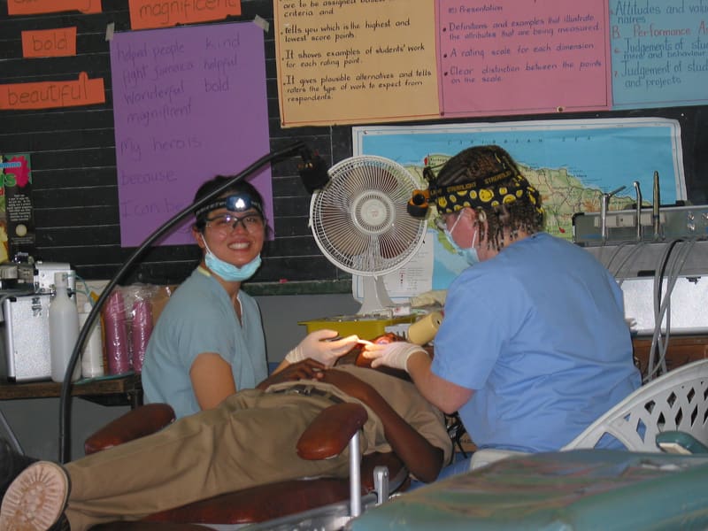 Volunteers providing dental care in a field clinic classroom